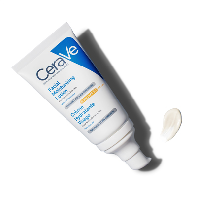 #2: AM Facial Moisturising Lotion SPF 50 laid on a white surface, with a swatch of the moisturising formula next to the product  